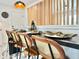 Kitchen island view featuring modern seating, place settings, and stylish wood slat partition at 1559 S Forest St, Denver, CO 80222