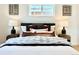 Spacious main bedroom with stylish decor, lamps, and luxurious linens at 1559 S Forest St, Denver, CO 80222