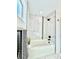 Bright bathroom showcasing a tub with a tiled shower surround and black shower head at 1559 S Forest St, Denver, CO 80222