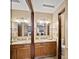 Bathroom featuring double vanity with granite countertops and decorative mirrors at 2800 Kalmia Ave # A310, Boulder, CO 80301