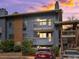 Charming condo exterior with two balconies, well-maintained landscaping, and brick accents at sunset at 2800 Kalmia Ave # A310, Boulder, CO 80301
