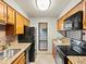 Well-equipped kitchen with granite countertops, modern appliances, and warm wood cabinetry at 2800 Kalmia Ave # A310, Boulder, CO 80301