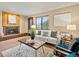 Inviting living room with a cozy fireplace, neutral sofa, and large window for natural light and views at 2800 Kalmia Ave # A310, Boulder, CO 80301