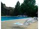 Large swimming pool with lounge chairs and surrounded by lush landscaping at 2800 Kalmia Ave # A310, Boulder, CO 80301