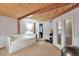 Light-filled bedroom with a daybed, walk-in closet, exposed beams, and carpeted floors at 1143 Auraria Pkwy # 101, Denver, CO 80204