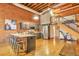 Open kitchen with stainless steel appliances and a spacious island with seating in a bright, open loft at 1143 Auraria Pkwy # 101, Denver, CO 80204