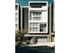 Modern townhome boasting a sleek design, multiple windows, balconies, and an attached two-car garage at 2556 18Th St, Denver, CO 80211