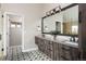 Primary bath featuring double sinks, wood cabinets, decorative tile and a glass enclosed shower at 1214 S Fillmore St, Denver, CO 80210