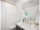 Clean bathroom with vanity, shower with white curtain, toilet and sink at 1214 S Fillmore St, Denver, CO 80210