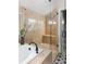 Bright bathroom featuring tiled shower with a frameless glass surround, built-in bench and a black faucet at 1214 S Fillmore St, Denver, CO 80210
