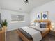 Cozy bedroom with a comfortable bed, bright window, and curated artwork creating a relaxing atmosphere at 1214 S Fillmore St, Denver, CO 80210