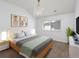 Bright bedroom with a neutral color scheme features a comfortable bed, a window, and contemporary decor at 1214 S Fillmore St, Denver, CO 80210