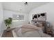 Inviting bedroom with plush carpet, large window and accent wall art pieces at 1214 S Fillmore St, Denver, CO 80210