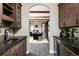 Elegant dining area with wood beams, stylish light fixture, and wood cabinets with granite counters at 1214 S Fillmore St, Denver, CO 80210