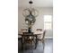 Cozy dining room with a rustic table, comfortable seating, and designer lighting at 1214 S Fillmore St, Denver, CO 80210