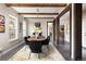 Elegant dining room with hardwood floors, wood beams, unique chandelier, and natural light at 1214 S Fillmore St, Denver, CO 80210