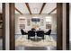 Open dining room area with hardwood floors, wood beams, unique chandelier, and natural light at 1214 S Fillmore St, Denver, CO 80210