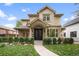 Stunning two-story home featuring a stone and stucco facade, manicured landscaping, and a welcoming entrance at 1214 S Fillmore St, Denver, CO 80210