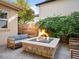 Backyard with stone fire pit, stone patio, and outdoor furniture at 1214 S Fillmore St, Denver, CO 80210