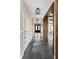 Bright foyer featuring wood floors, an eye-catching light fixture, and natural wood beams at 1214 S Fillmore St, Denver, CO 80210