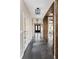 Hallway with dark hardwood floors, beams and visible front door at 1214 S Fillmore St, Denver, CO 80210
