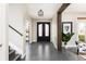 Entryway featuring dark hardwood floors, decorative beams, and a modern chandelier at 1214 S Fillmore St, Denver, CO 80210