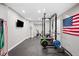 A home gym includes weights, a television, and other exercise equipment at 1214 S Fillmore St, Denver, CO 80210