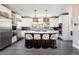 A modern kitchen with a large island, stainless steel appliances, and stylish pendant lighting at 1214 S Fillmore St, Denver, CO 80210