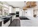 Modern kitchen features a large island, stainless steel appliances, and ample counter space with light fixtures at 1214 S Fillmore St, Denver, CO 80210