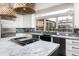 Modern kitchen with stainless steel appliances, sleek countertops, an island cooktop, and a farmhouse sink at 1214 S Fillmore St, Denver, CO 80210