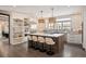 Gourmet kitchen boasts a large center island, counter seating, and stainless steel appliances at 1214 S Fillmore St, Denver, CO 80210