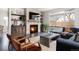 Inviting living room featuring a stone fireplace, dark wood floors and an abundance of natural light at 1214 S Fillmore St, Denver, CO 80210