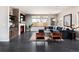 Bright living room with a cozy fireplace, large windows, stylish furniture, and dark hardwood flooring at 1214 S Fillmore St, Denver, CO 80210
