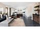 Open-concept living space featuring hardwood floors and seamless transition to a modern kitchen with a center island at 1214 S Fillmore St, Denver, CO 80210