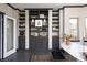 Stylish living room with custom built-in shelving, wood floors, and neutral paint at 1214 S Fillmore St, Denver, CO 80210