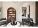 Elegant sitting room with arched bookcase featuring decorative items and view of hallway at 1214 S Fillmore St, Denver, CO 80210