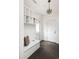 Bright mudroom features built-in shelves, a bench with storage, and stylish herringbone flooring at 1214 S Fillmore St, Denver, CO 80210