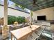 Covered outdoor kitchen with large stone table, fire pit, and grill area at 1214 S Fillmore St, Denver, CO 80210