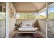Relaxing covered patio with comfortable seating and a view of mature trees at 1214 S Fillmore St, Denver, CO 80210