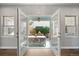 View of patio with outdoor dining set and fire pit through french doors at 1214 S Fillmore St, Denver, CO 80210