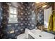 Charming powder room featuring unique wallpaper and elegant fixtures at 1214 S Fillmore St, Denver, CO 80210