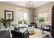 Sitting area with dark hardwood floors, ample natural light, and French door access at 1214 S Fillmore St, Denver, CO 80210