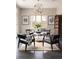 Sitting area showcases dark hardwood floors, unique orb chandelier, and ample natural light at 1214 S Fillmore St, Denver, CO 80210