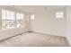 Spacious bedroom with plush carpeting and large windows providing natural light at 15261 Fillmore St, Thornton, CO 80602