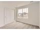 Bright bedroom featuring large windows and a spacious closet with sliding doors at 15261 Fillmore St, Thornton, CO 80602