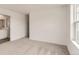 A well-lit bedroom with neutral carpet and a view into the adjoining bathroom at 15261 Fillmore St, Thornton, CO 80602