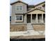 Charming townhome showcasing a welcoming front porch and classic design elements at 15261 Fillmore St, Thornton, CO 80602