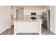 Bright, white kitchen featuring an island with sink, stainless steel appliances, and plenty of cabinet space at 15261 Fillmore St, Thornton, CO 80602