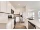 Modern kitchen with stainless steel appliances, quartz countertops, and ample cabinet space at 15261 Fillmore St, Thornton, CO 80602