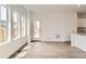 Bright living room featuring natural light, light wood flooring, and access to the outdoor deck at 15261 Fillmore St, Thornton, CO 80602